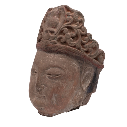 520 - A Chinese carved stone head of Guanyin with serene expression and wearing ornate headress, 35cm.