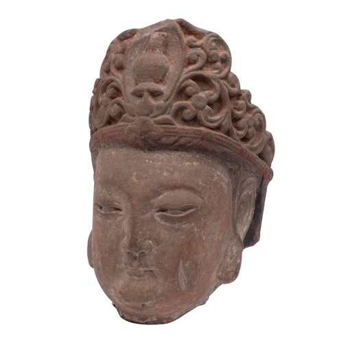 520 - A Chinese carved stone head of Guanyin with serene expression and wearing ornate headress, 35cm.