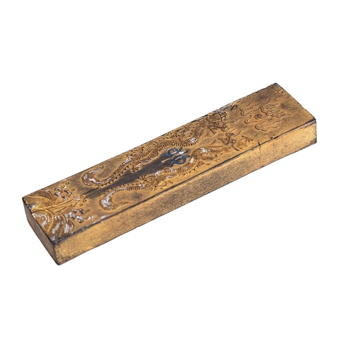 525 - A Chinese ink stick, Qing Dynasty carved with opposing dragons chasing a flaming pearl, the reverse ... 