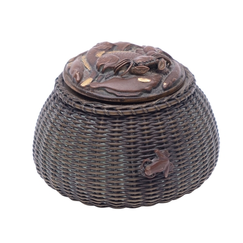 537 - A Japanese patinated mixed metal inkwell in the form of a wicker lobster pot, the cover relief decor... 