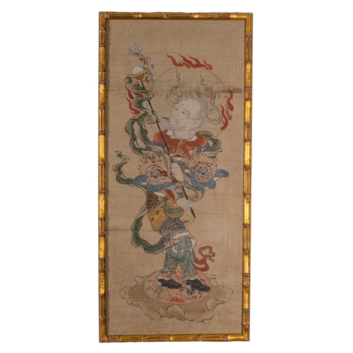 540 - A Japanese gouache, of a flaming deity holding a staff, 73 x 32, in gilt faux bamboo frame.