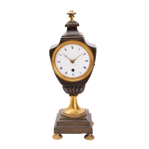 560 - A late-Georgian French bronze and brass urn clock having an eight-day duration timepiece movement, t... 