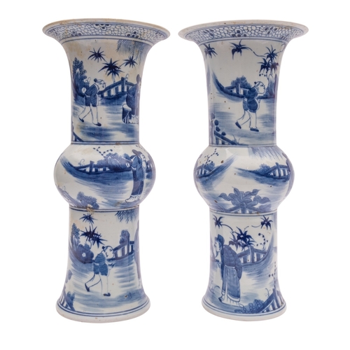 64 - A pair of Chinese 'Gu' form vases, painted in blue with figures in fenced gardens, 20th century, 39c... 