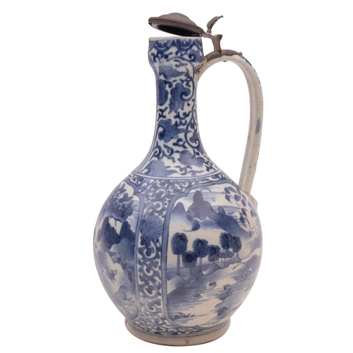 79 - A Japanese Arita ewer of garlic shape with strap handle and pewter mounts, painted in blue with land... 