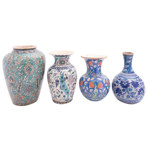 86 - Four Isnik inspired pottery vases, each profusely decorated with flowers and foliage, tallest vase 3... 