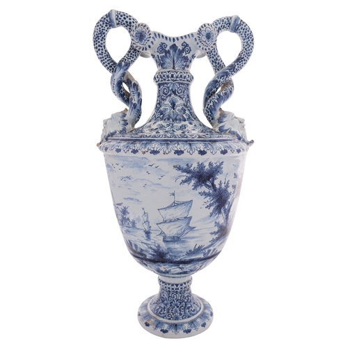 90 - A large Dutch Delft pedestal vase with entwined serpent handles terminating in grotesque masks, pain... 