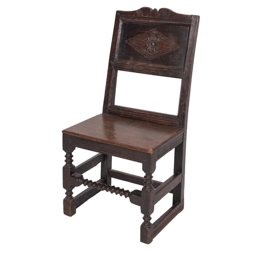 901 - A Jacobean oak backstool, probably Lancashire, circa 1680; the rectangular backrest with recessed re... 