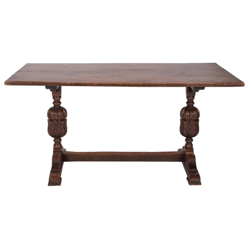 902 - An oak trestle table in Elizabethan style, early 20th century; the rectangular top on twin knopped, ... 