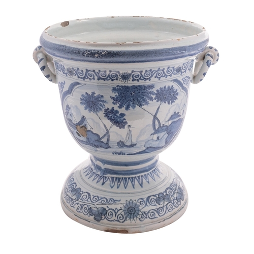 94 - A large Dutch Delft blue and white jardiniere with rope twist handles, painted with panels of sailin... 