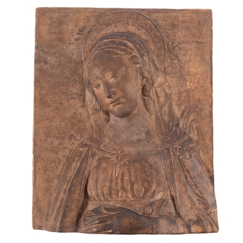 95 - A terracotta high relief of a female Saint 39 x 31cm [broken across and repaired].