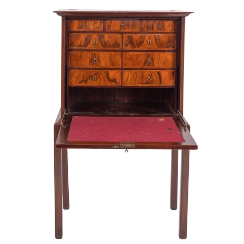 967 - A walnut secretaire chest on stand in early 18th century taste, early 20th century; the top with mou... 