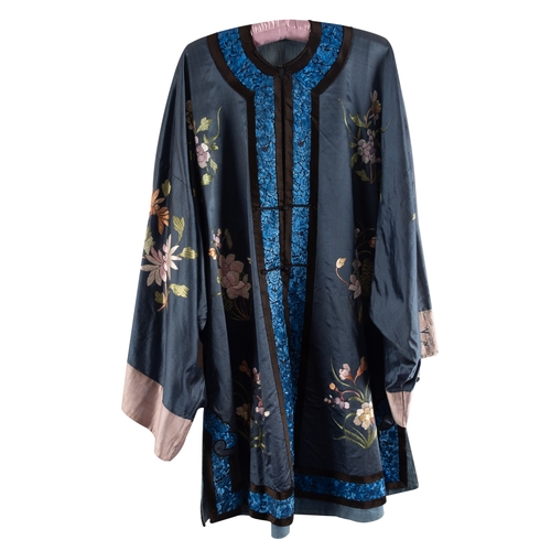 427A - A Chinese blue silk robe, with hand-embroidered cerulean floral panels at the trims and large colour... 