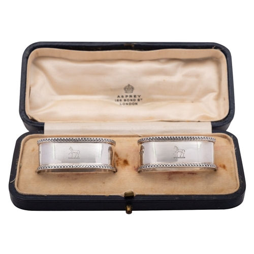 148 - A pair of George V cased silver napkin rings by Asprey & Co Ltd, London 1925, of oval form, gardoone... 