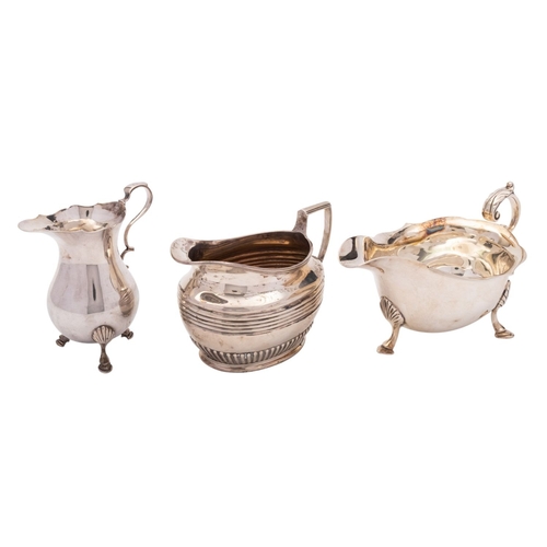 22 - Two silver cream jugs and a sauce boat, the late Victorian oval jug by Henry Stratford, Sheffield 18... 