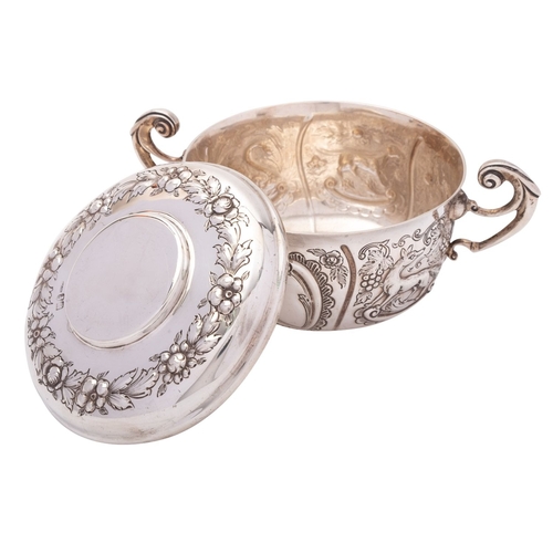 269 - An Irish silver porringer and cover, M.H Dublin 1904, in the Carolean style, decorated with birds, a... 