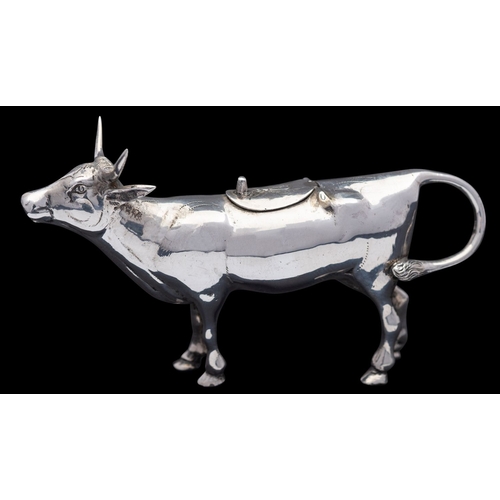 319 - A German silver cow creamer, stamped STERLING, GERMANY and 925, 1950s, with a bee atop the hinged co... 