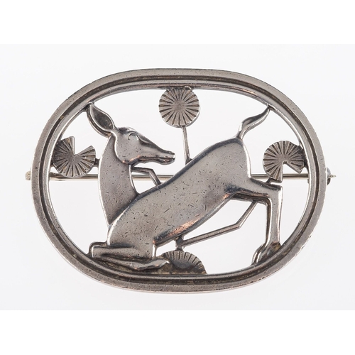 362 - Arno Malinowski, for Georg Jensen, a silver oval openwork brooch depicting a kneeling deer with foli... 