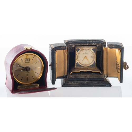 446 - Jaeger, a small gilt travelling alarm clock the dial with baton numerals, alarm setting aperture and... 