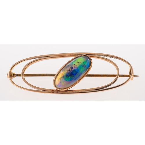 478 - A stylised oval opal brooch, an openwork brooch set with an elongated oval opal cabochon, pin and ca... 