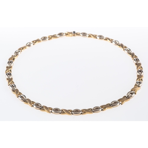 511 - A 9ct yellow and white gold necklace, of alternating oval links & brushed finish 'cross' links, push... 