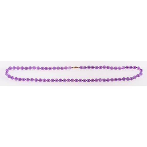 524 - An Amethyst bead necklace, circular 8mm amethyst beads to a 9ct yellow gold clasp, clasp marked 9ct,... 