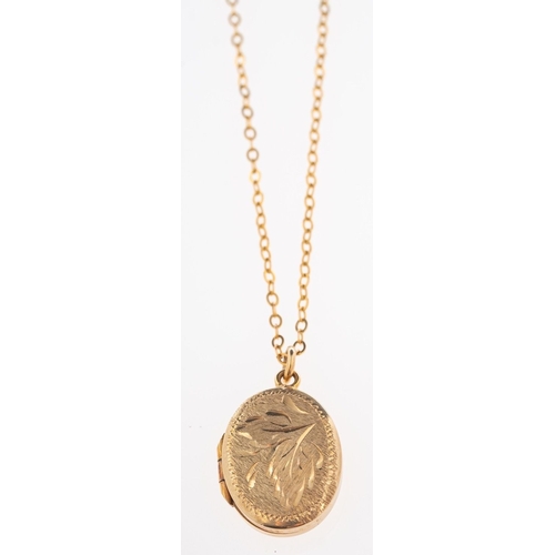 537 - A locket and chain, an oval locket with foliate engraving. marked on reverse 9ct BK & FT, on a fine ... 