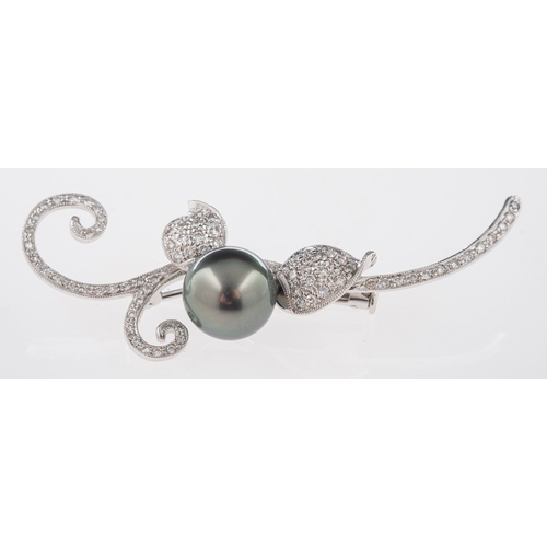 549 - A leaf spray brooch, set centrally with a 10mm black cultured pearl with brilliant-cut diamonds set ... 