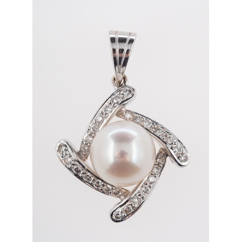 550 - A pearl and diamond pendant, set with a 9mm cultured pearl and twenty-eight small brilliant-cut diam... 