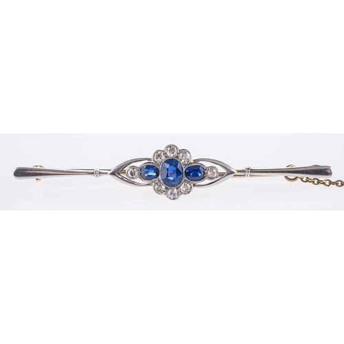 571 - An Edwardian bar brooch, of flowerhead design and set with three oval-cut sapphires, surrounded by s... 