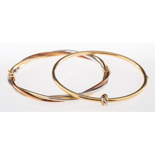 576 - Two gold bangles, a three-coloured twist design bangle, hinged, inner diameter approx 5.7cm, marked ... 