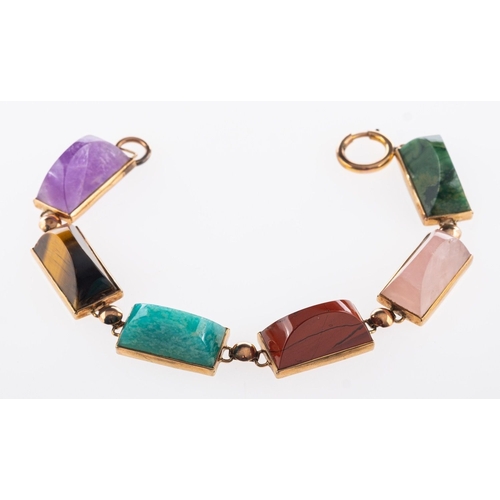 587 - A multi-stone bracelet, set with six different semi-circular cabochon cut quartz stones to include r... 