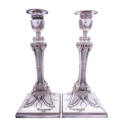 10 - A pair of Sheffield Plated candlesticks of Robert Adam design, with ram's head motifs, 29.5cm high t... 