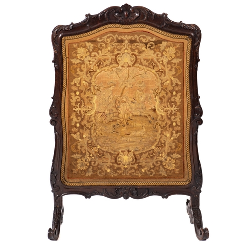 181 - A Victorian carved walnut and Berlin woolwork firescreen, mid 19th Century, the needlework cartouche... 