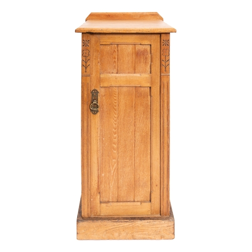 194 - A late Victorian oak pot cupboard in Arts and Crafts style, circa 1900, enclosed by a panel door on ... 