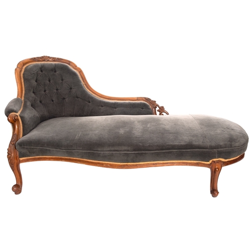 195 - A Victorian carved walnut and upholstered chaise longue, circa 1870, the three quarter shaped and up... 