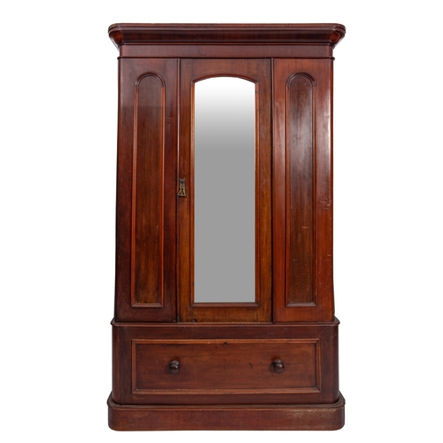 207 - A Victorian mahogany wardrobe with a moulded cornice enclosed by a central mirror panel, door with s... 