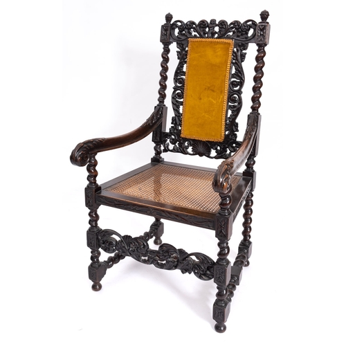 211 - A carved beechwood open armchair in the Charles II manner, late 19th Century, the upholstered panel ... 