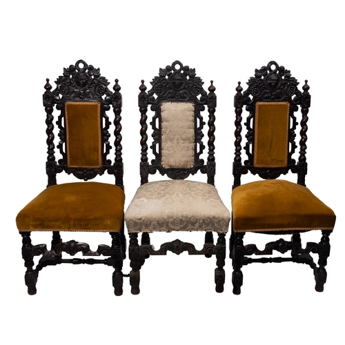 212 - A set of three carved oak hall or dining chairs in the Carolean style, the upholstered panel backs w... 