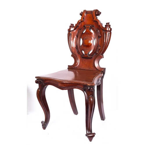 214 - A Victorian carved mahogany hall chair, the cartouche shaped back with scroll cresting having serpen... 