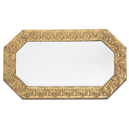 215 - A Victorian repousse brass framed octagonal wall mirror, circa 1900; the frame with Rocaille and ant... 