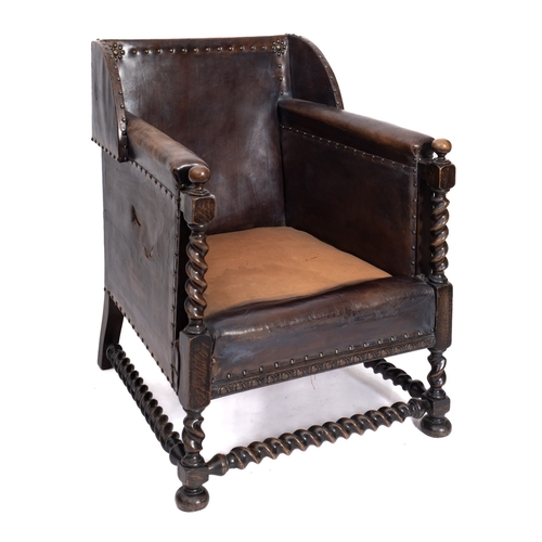 228 - A leather covered and brass studded armchair in the 17th Century taste, circa 1920, with semi-wing b... 