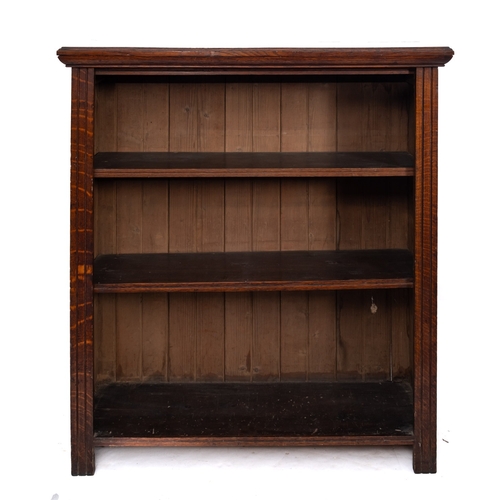 229 - An Edwardian low oak open bookcase, fitted with adjustable shelves, between channel moulded uprights... 