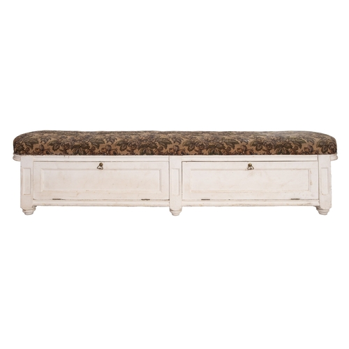 236 - A cream painted ottoman window seat with upholstered tapestry top and two hinged flaps to the compar... 