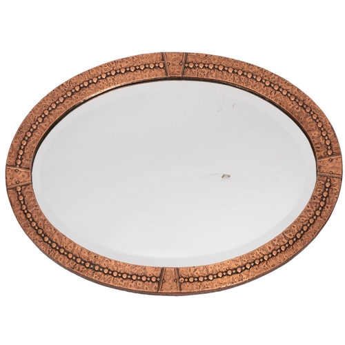 238 - A repousse copper framed oval wall mirror in Arts & Crafts style, early 20th century; 70 x 50cm; an ... 