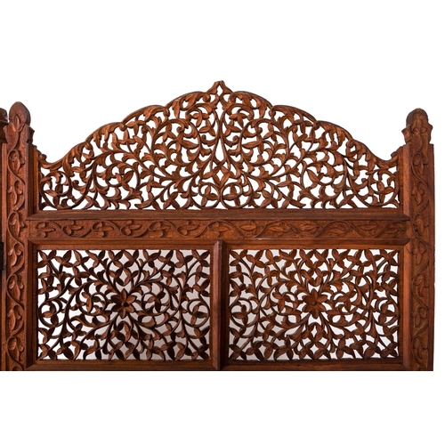 246 - An Anglo Indian carved and stained hardwood three-fold room screen, early 20th Century, with openwor... 