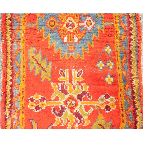 265 - A Turkey runner of traditional design and colours with five geometric medallions, 342cm x 90cm, toge... 