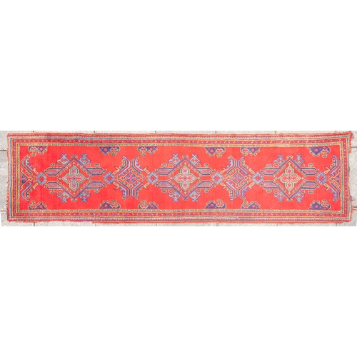 265 - A Turkey runner of traditional design and colours with five geometric medallions, 342cm x 90cm, toge... 