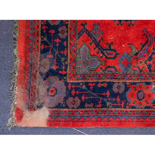 267 - A Turkey carpet with traditional design and colours, 336cm x 330cm (damaged)