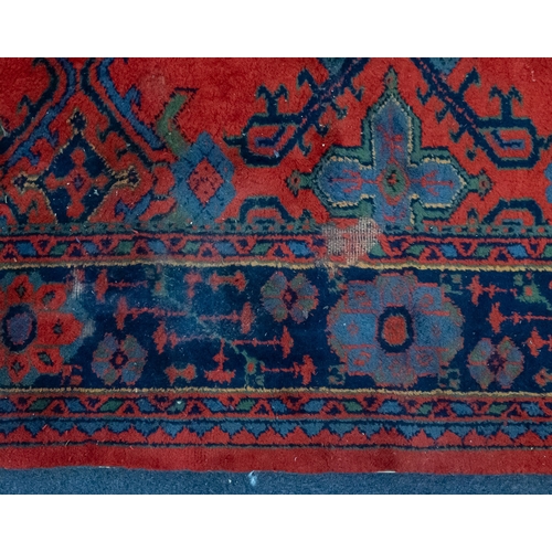 267 - A Turkey carpet with traditional design and colours, 336cm x 330cm (damaged)