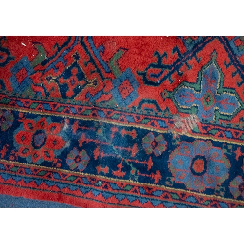 267 - A Turkey carpet with traditional design and colours, 336cm x 330cm (damaged)